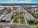Aerial view of a meticulously landscaped community featuring rows of townhomes and a central park with a gazebo at 3368 Parkchester Square Blvd # 104, Orlando, FL 32835