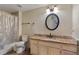 Bathroom with granite countertop, round mirror, and neutral color palette offers a clean, modern aesthetic at 3368 Parkchester Square Blvd # 104, Orlando, FL 32835