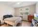 Cozy bedroom with a window, wood-look flooring, and neutral-toned walls at 3368 Parkchester Square Blvd # 104, Orlando, FL 32835