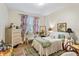 Bright bedroom with wooden floors, decorated with floral curtains, colorful rug, and bedside tables at 3368 Parkchester Square Blvd # 104, Orlando, FL 32835