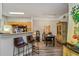 Open dining area with breakfast bar seating adjacent to the kitchen, and wood-look floors at 3368 Parkchester Square Blvd # 104, Orlando, FL 32835