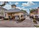 Gated community entrance with a clock tower, security gate, and well-maintained landscaping at 3368 Parkchester Square Blvd # 104, Orlando, FL 32835