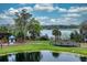 Scenic lake view featuring a gazebo, lush greenery, and a walking path surrounding the tranquil water at 3368 Parkchester Square Blvd # 104, Orlando, FL 32835
