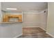 Open-concept area with a breakfast bar, wood floors, and neutral paint at 3368 Parkchester Square Blvd # 104, Orlando, FL 32835