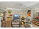 Cozy living room with a ceiling fan, wood-look floors, and an arched doorway to another room at 3368 Parkchester Square Blvd # 104, Orlando, FL 32835