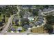 Wide aerial view of a community with clubhouse, pool, walking paths and mature trees at 3390 Melissa Ln, The Villages, FL 32163