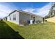 Backyard with a manicured lawn, patio, and a side view of the home at 3390 Melissa Ln, The Villages, FL 32163