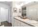 Well-lit bathroom with double sinks, a large mirror, and neutral decor at 3390 Melissa Ln, The Villages, FL 32163
