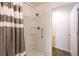 Clean bathroom featuring a shower with a gray and white striped curtain at 3390 Melissa Ln, The Villages, FL 32163