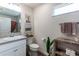 Bright bathroom with decorative art, neutral countertop, vanity, and modern shelving for towels at 3390 Melissa Ln, The Villages, FL 32163