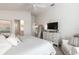 Bright, airy bedroom with a white bed and a view into the ensuite bathroom at 3390 Melissa Ln, The Villages, FL 32163