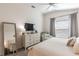 Serene bedroom with a comfortable bed, dresser, and a cozy armchair at 3390 Melissa Ln, The Villages, FL 32163