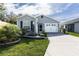 Charming single-story home featuring a well-manicured lawn and a two-car garage at 3390 Melissa Ln, The Villages, FL 32163