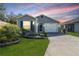 Charming single-story home featuring a well-manicured lawn and a two-car garage at 3390 Melissa Ln, The Villages, FL 32163