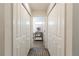 Hallway featuring linen closet with stacked towels and natural wood shelving; bright natural light at 3390 Melissa Ln, The Villages, FL 32163
