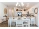 Open kitchen with white cabinets, stainless steel appliances, and large island seating at 3390 Melissa Ln, The Villages, FL 32163