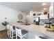 Open-concept kitchen with countertop seating, stainless steel sink, neutral tones, and stylish decorative touches at 3390 Melissa Ln, The Villages, FL 32163