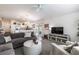 Cozy living room showcasing an open floor plan and a large gray couch with white pillows at 3390 Melissa Ln, The Villages, FL 32163