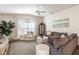 Comfortable living room featuring a plush sofa, large windows, and stylish decor at 3390 Melissa Ln, The Villages, FL 32163