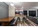 Well-lit dining area open to the kitchen, perfect for entertaining, featuring modern decor and wood-look floors at 384 Coral Beach Cir, Casselberry, FL 32707