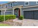Close-up of a townhome's front door framed by an archway and manicured landscaping creating a welcoming entrance at 384 Coral Beach Cir, Casselberry, FL 32707