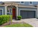 Charming blue two-story townhome featuring a paver driveway, an attached garage, and manicured landscaping at 384 Coral Beach Cir, Casselberry, FL 32707