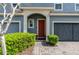 Close-up of a townhome's front door framed by an archway and manicured landscaping creating a welcoming entrance at 384 Coral Beach Cir, Casselberry, FL 32707