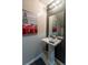 Modern half-bathroom featuring an elegant pedestal sink and decorative accents at 384 Coral Beach Cir, Casselberry, FL 32707