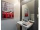 Stylish half bath with telephone artwork and sleek fixtures at 384 Coral Beach Cir, Casselberry, FL 32707