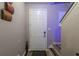 Hallway with a white front door, wood-look floors, and wall decor leading to the upper level of the home at 384 Coral Beach Cir, Casselberry, FL 32707