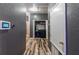 Convenient hallway laundry area with modern appliances and a security system panel at 384 Coral Beach Cir, Casselberry, FL 32707