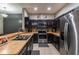 Bright kitchen featuring stainless steel appliances, dark cabinetry and a breakfast bar connecting the dining area at 384 Coral Beach Cir, Casselberry, FL 32707