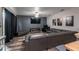Spacious living room with a large sectional sofa, sleek entertainment center, and modern ceiling fan at 384 Coral Beach Cir, Casselberry, FL 32707