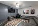 Inviting living area with gray leather sectional, TV, and modern entertainment center at 384 Coral Beach Cir, Casselberry, FL 32707