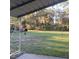 View from a covered area overlooking the large backyard with trees and natural surroundings at 43648 S Island Dr, Paisley, FL 32767