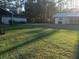Spacious backyard with lush green grass, offering plenty of room for outdoor activities at 43648 S Island Dr, Paisley, FL 32767