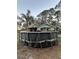 View of backyard featuring an above ground swimming pool, mature trees, and a single story home at 43648 S Island Dr, Paisley, FL 32767