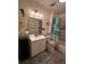 Bathroom with nautical decor, updated vanity, mirror, lighting, and a shower with a curtain at 43648 S Island Dr, Paisley, FL 32767