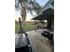Back deck with an outdoor kitchen including a barbecue, seating, and a view of the green backyard at 43648 S Island Dr, Paisley, FL 32767