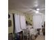 Cozy dining room with green walls, a table set with white linens, and bright windows at 43648 S Island Dr, Paisley, FL 32767