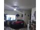 Relaxing living room features a ceiling fan and a large television above an entertainment center at 43648 S Island Dr, Paisley, FL 32767