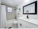 Modern bathroom offers a sleek vanity, decorative mirror, updated shower/bath, and window for great natural lighting at 508 Boxelder Ave, Altamonte Springs, FL 32714