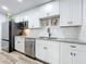 Well-lit kitchen with stainless steel appliances, white cabinets, and granite countertops at 508 Boxelder Ave, Altamonte Springs, FL 32714