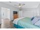 Open bedroom featuring wood-look floors, closet space, and TV above a chest of drawers at 511 Bonita Dr, Lady Lake, FL 32159