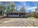 Rear view of property, showing backyard and screened-in porch at 6213 Highland Ave, Leesburg, FL 34748