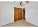 Bedroom featuring neutral carpet, closet, and natural light at 6213 Highland Ave, Leesburg, FL 34748