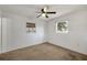 Cozy bedroom featuring carpet, white walls and trim, with two windows at 6213 Highland Ave, Leesburg, FL 34748