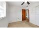 Bright bedroom with neutral carpet, ceiling fan, and door to another room at 6213 Highland Ave, Leesburg, FL 34748