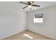 Bright bedroom with neutral carpet, ceiling fan, and natural light from the window at 6213 Highland Ave, Leesburg, FL 34748