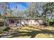 Well-maintained single-story home with red brick accents and lush lawn at 6213 Highland Ave, Leesburg, FL 34748